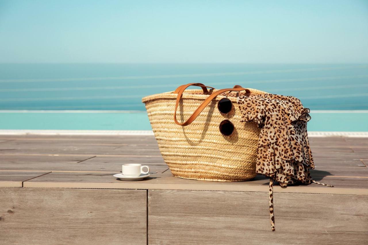 Toscana Charme Resort Tirrenia Esterno foto A straw beach bag